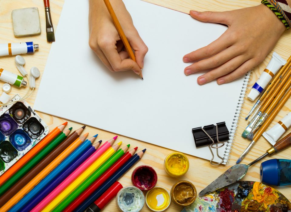 hands of a person taking drawing lessons