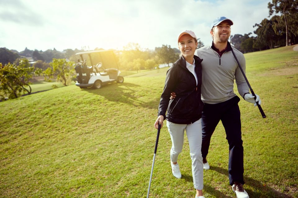 couple participating in a golf tournament