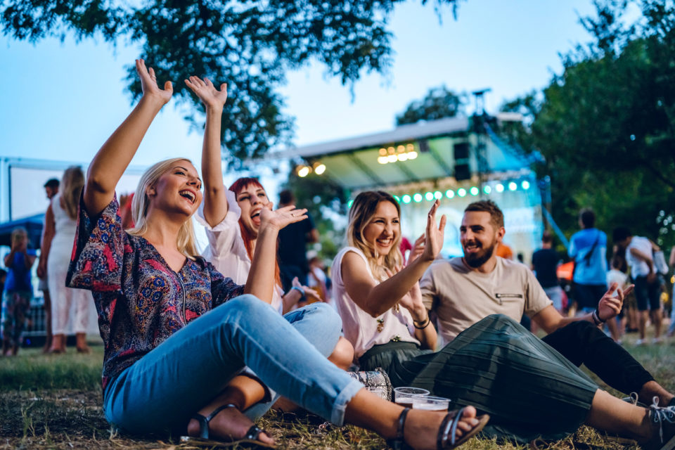 group of friends listening to music at a concert together