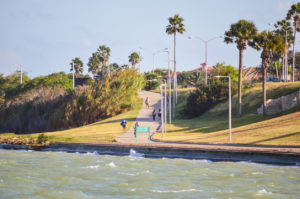 People out exercising and enjoying a late evening along the seashore in Corpus Christi, Texas in October.