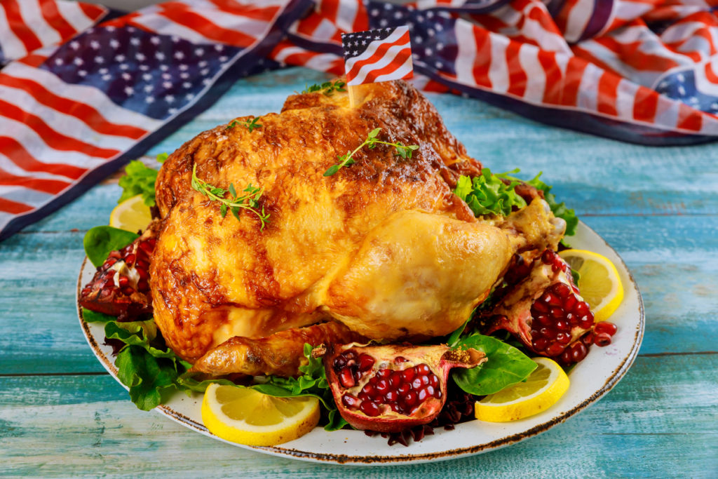 Roasted pheasant on plate with American flag.